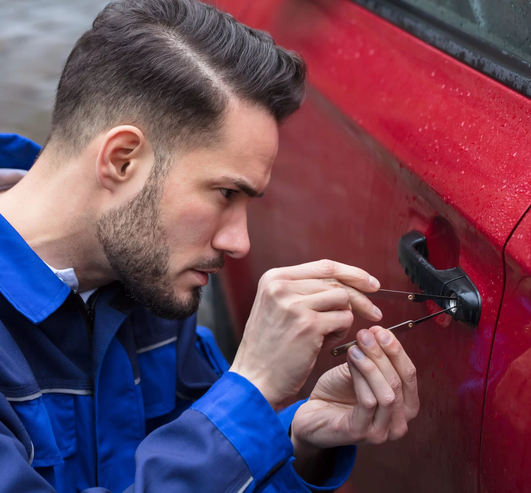 Automotive locksmith assisting with car lockouts, key fob programming, and transponder key replacements